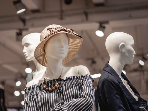 Three shop mannequins in a clothes store