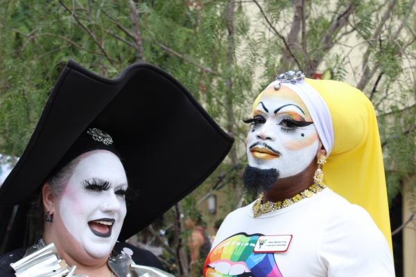 Two people in gender-blending clothes and makeup.